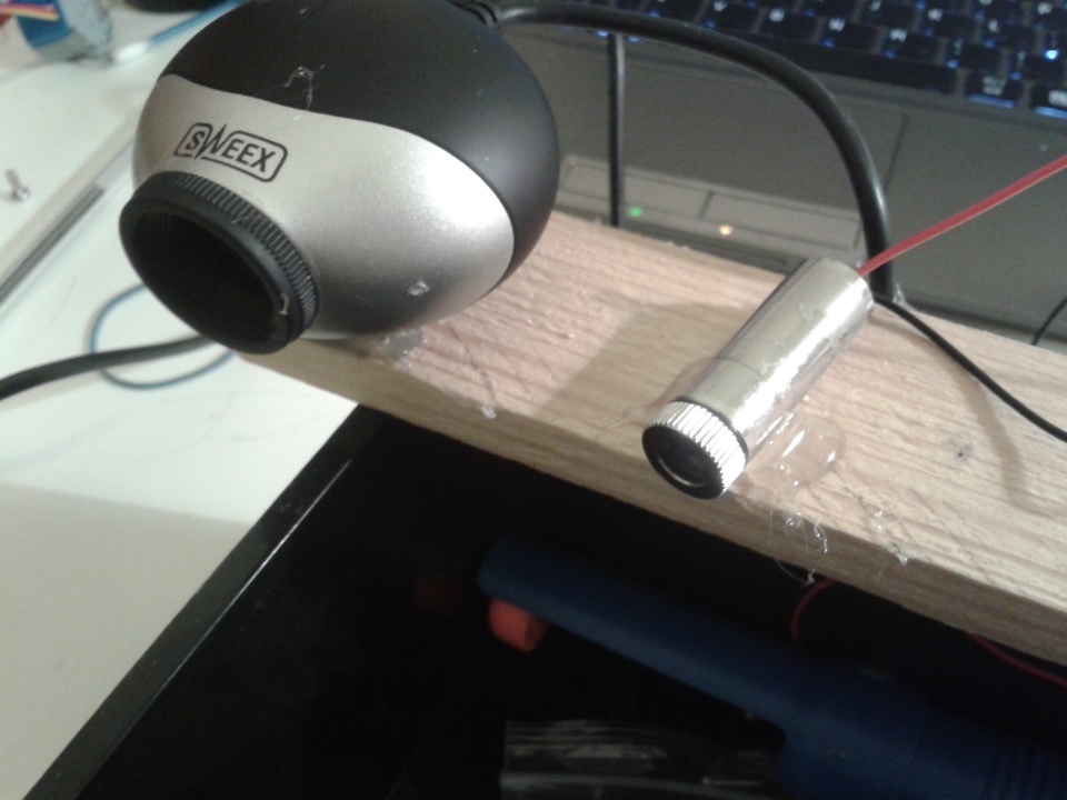 Webcam and laser hot glued to a piece of wood
